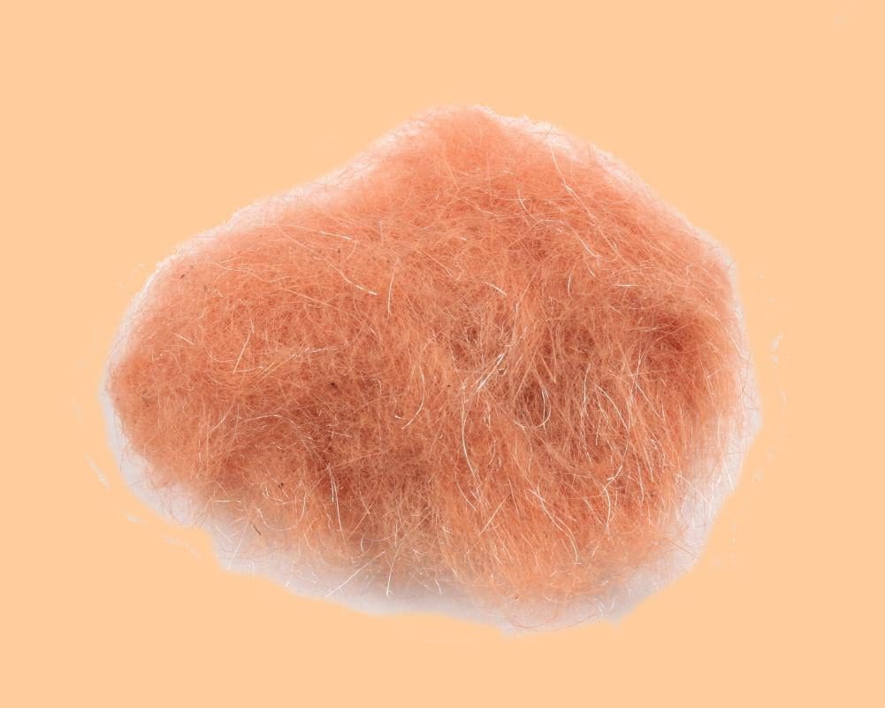 Close-up of a pinkish fuzzy textured object on a plain background.