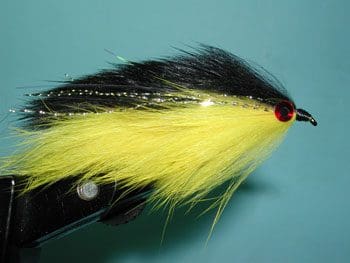 A collection of shiny metallic chess pawns arranged on a peach background.