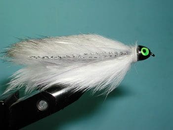 A collection of shiny metallic chess pawns arranged on a peach background.