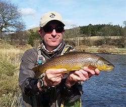 Cannabis products including dried marijuana and a container with a label.