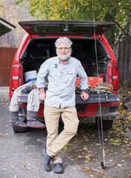 A collection of shiny metallic chess pawns arranged on a peach background.