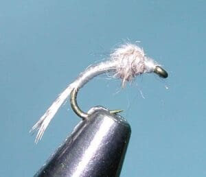 Fishing fly with metallic hook and thread.