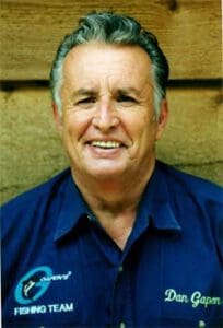 A collection of shiny metallic chess pawns arranged on a peach background.