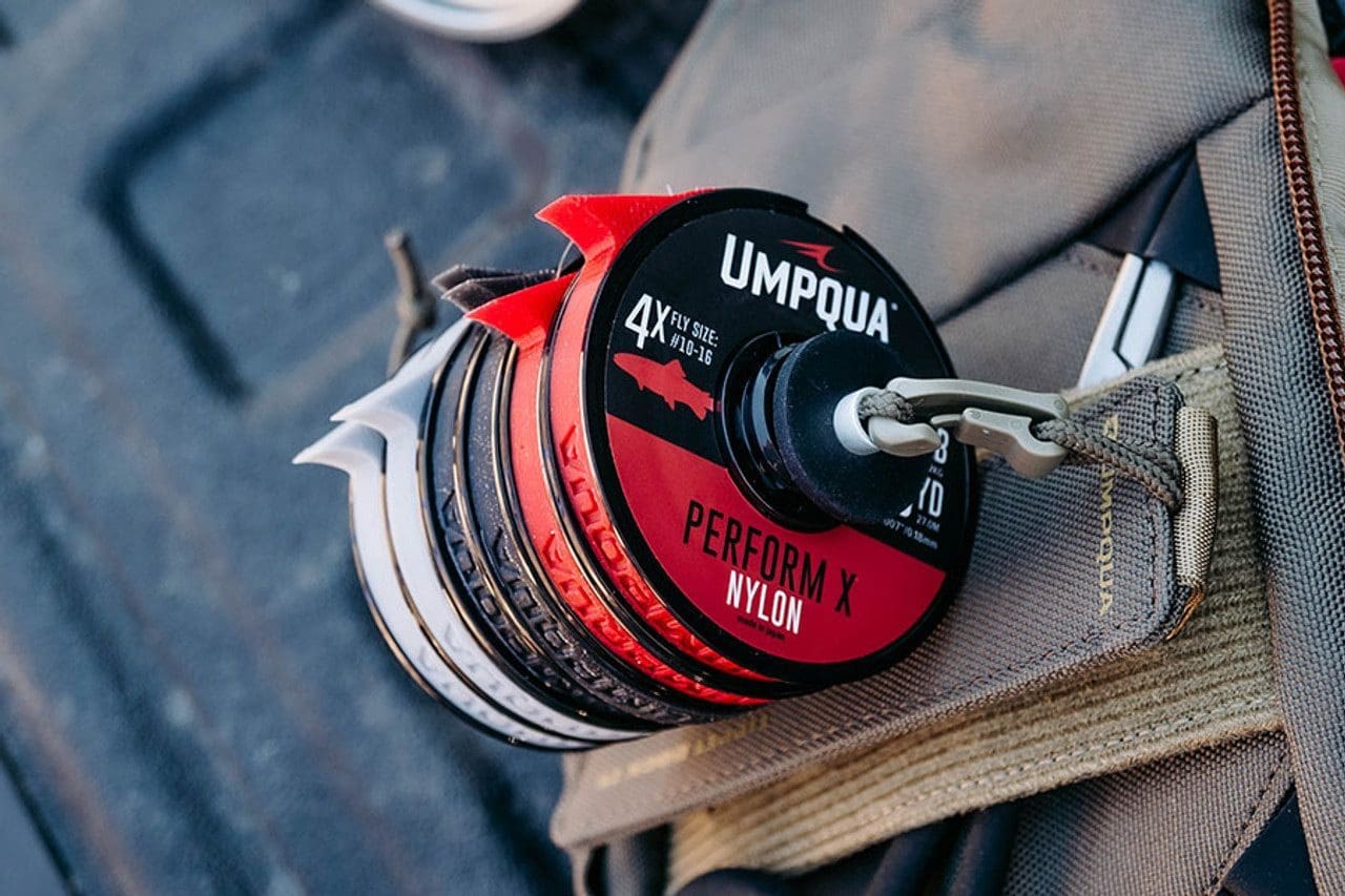 Close-up of a Umpqua performance reel on fishing gear.